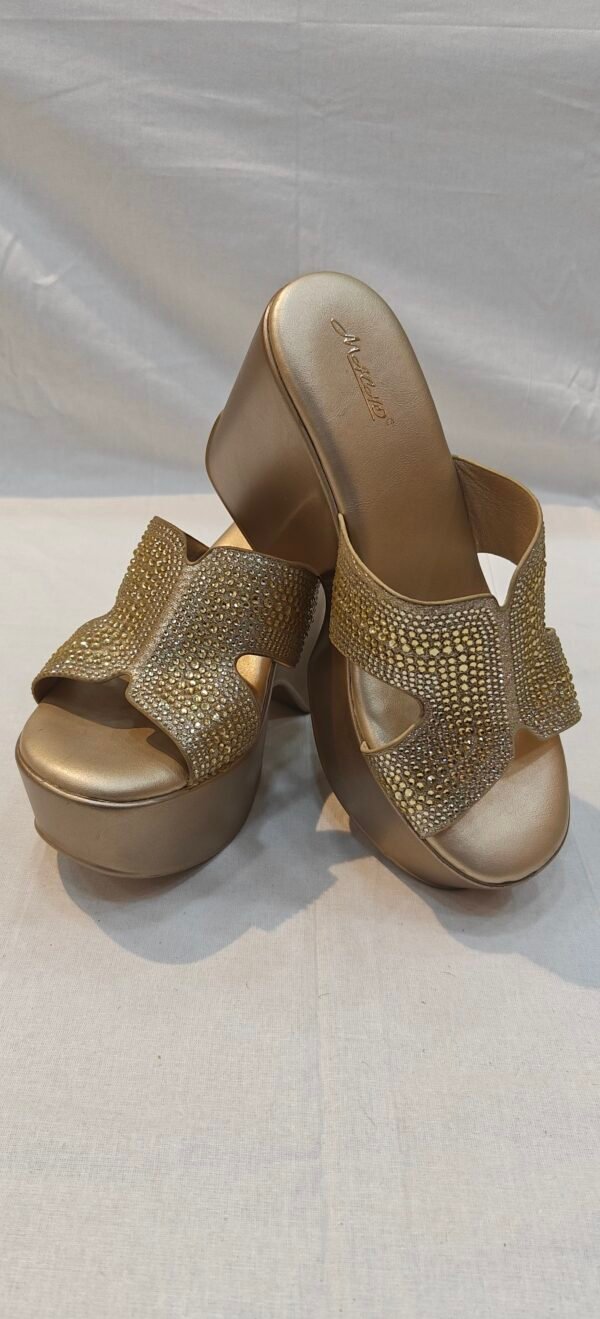 ProductStep out in effortless elegance with the Metro Women's Light Golden Embellished Platform Wedge Heels.