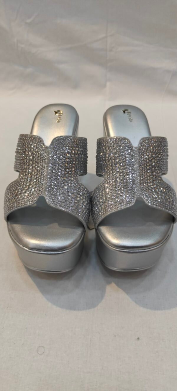 Step out in effortless elegance with the Metro Women's Metallic Silver Embellished Platform Wedge Heels.